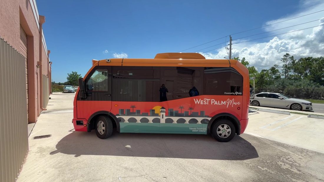 Electric shuttle bus with a full colour transit wrap